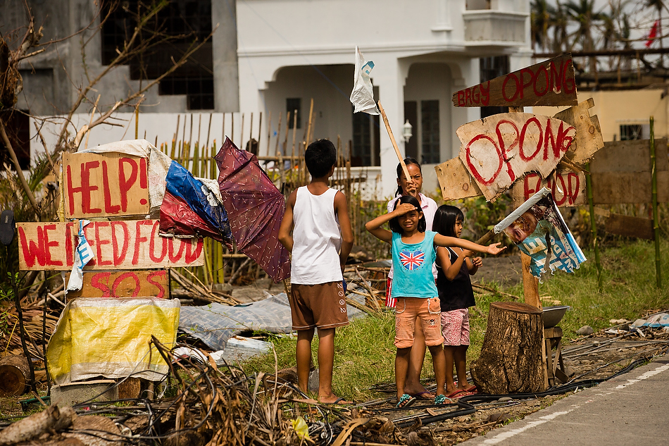 Children beg for food and supplies near Tacloban City, Leyte province, Philippines on Tuesday, Nov. 19, 2013. The city and surrounding area were hit hardest by Typhoon Haiyan, leaving thousands dead and millions displaced. Photo by Erik M. Lunsford/LCMS
