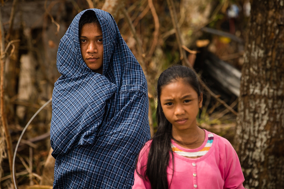 Displaced residents beg for food near Tacloban City, Leyte province, Philippines on Tuesday, Nov. 19, 2013. The city and surrounding area were hit hardest by Typhoon Haiyan, leaving thousands dead and millions displaced. Photo by Erik M. Lunsford/LCMS