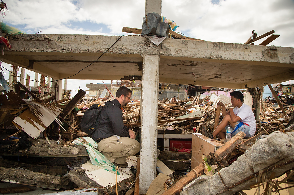 Rev. Ross Johnson, director of LCMS Disaster Response, talks with Tacloban resident Henry Ragot amongst the debris field in Tacloban City, Leyte province, Philippines on Tuesday, Nov. 19, 2013. Typhoon Haiyan caused widespread destruction, killing thousands and displacing millions of people. Photo by Erik M. Lunsford/LCMS