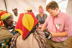 Daniel Boeder, a second-year medical student and a member of Trinity Lutheran Church, Springfield, Ill. works with patients at the LCMS Mercy Medical Team clinic on Monday, June 20, 2016, in Nataparkakono, a village in Turkana, Kenya. LCMS Communications/Erik M. Lunsford