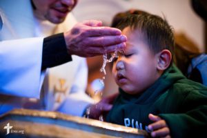 The Rev. Matthew Clark baptizes 21 Nepali immigrants, including Sajjal Tamang, on Sunday, Jan. 12, 2014, at Ascension Lutheran Church in St. Louis, Mo. LCMS Communications/Erik M. Lunsford