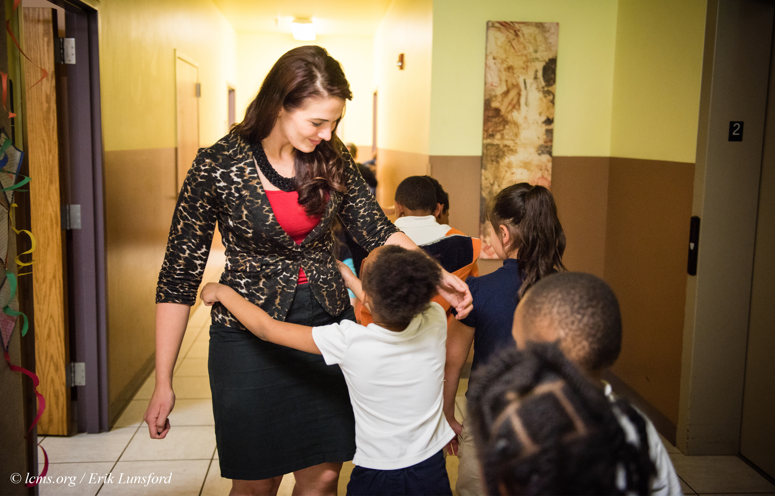 Principal Tiffany Venegas hugs students on their way to class at the Renaissance School, part of Lutheran Urban Mission Initiative, Inc., on Wednesday, May 20, 2015, in Mt. Pleasant, Wis. LCMS Communications/Erik M. Lunsford
