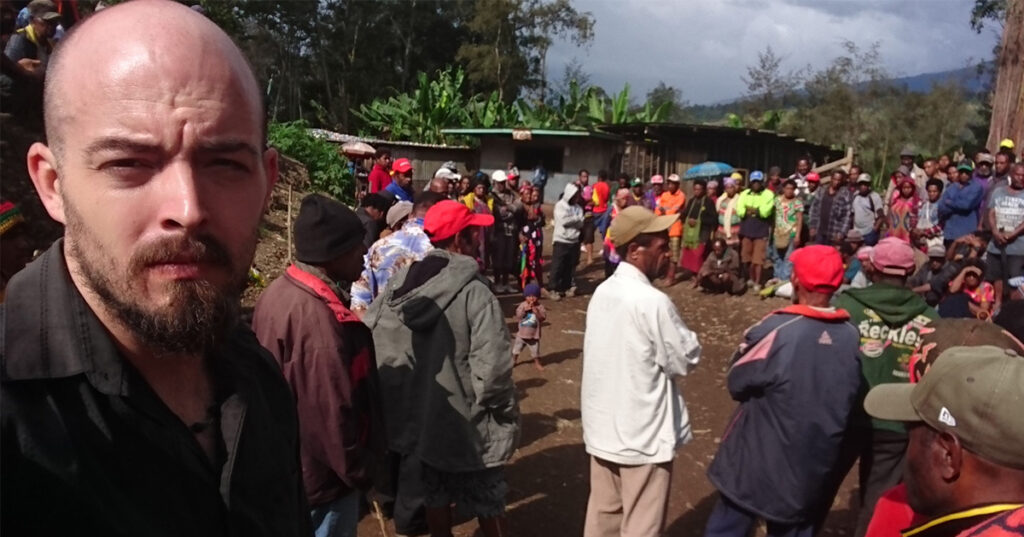 Anton Lutz pauses to capture the scene after returning the broken body of sanguma-violence victim Shirley Kangup to her extended family for burial. After her torture, Lutz drove Kangup through the night to get her to the best hospital in the region. She died six days later. ANTON LUTZ