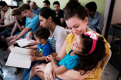 Jamielynn Tinkey, LCMS missionary to the Dominican Republic, cares for a young girl during worship at the LCMS Latin America regional office in Santiago, Dominican Republic, on Tuesday, Oct. 17, 2017. LCMS Communications/Erik M. Lunsford