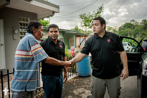 Evangelist William Torres from the Casa de Amparo y Respuesta a Desastre (CARD), or House of Refuge and Mercy Response mercy center, along with the Rev. Gustavo Maita, pastor of Iglesia Luterana Principe de Paz (Prince of Peace Lutheran Church), Mayagüez, Puerto Rico, say goodbye to a resident of the community who was affected by Hurricane Maria on Tuesday, April 17, 2018 in Mayagüez. LCMS Communications/Erik M. Lunsford