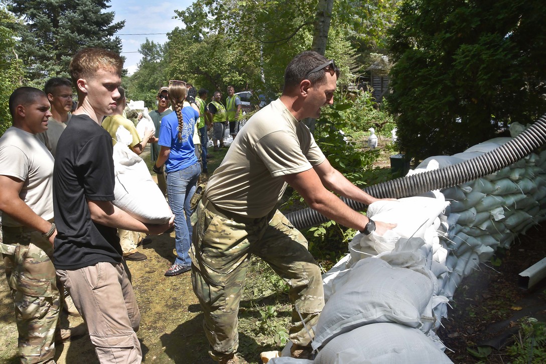 Wisconsin National Guard Soldiers from the Madison, Wis.-based 1st Squadron, 105th Cavalry, build a sandbag retaining wall around a residence in Madison Aug. 27. Approximately 85 Wisconsin National Guard Soldiers and Airmen were called to state active duty to assist civil authorities in the wake of torrential rains Aug. 20-21. Wisconsin National Guard photo by Capt. Joe Trovato