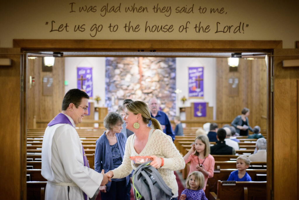 The Rev. Mark Nierman, pastor of Mount Olive Lutheran Church, greets parishioner Shelley Haagenson and her three children, Delaney, Bella, and Oliver, after Lenten worship on Wednesday, March 2, 2016, in Loveland, Colo. LCMS Communications/Erik M. Lunsford