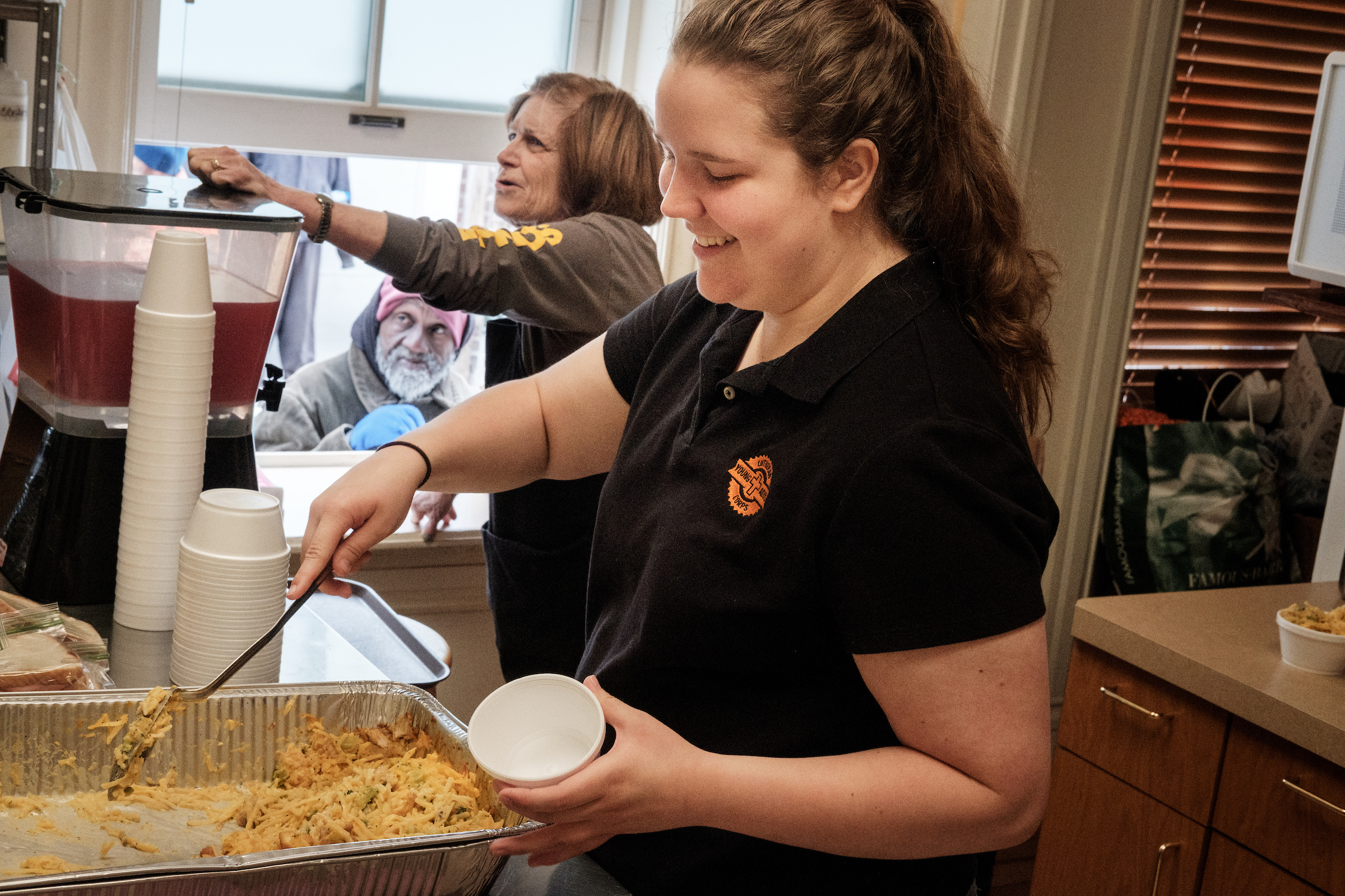 Young Adult Corps participant Lara McComack helps distribute food with Cecelia Andres to homeless men and women early Thursday, April 19, 2018, at Trinity Lutheran Church, St. Louis. LCMS Communications/Erik M. Lunsford