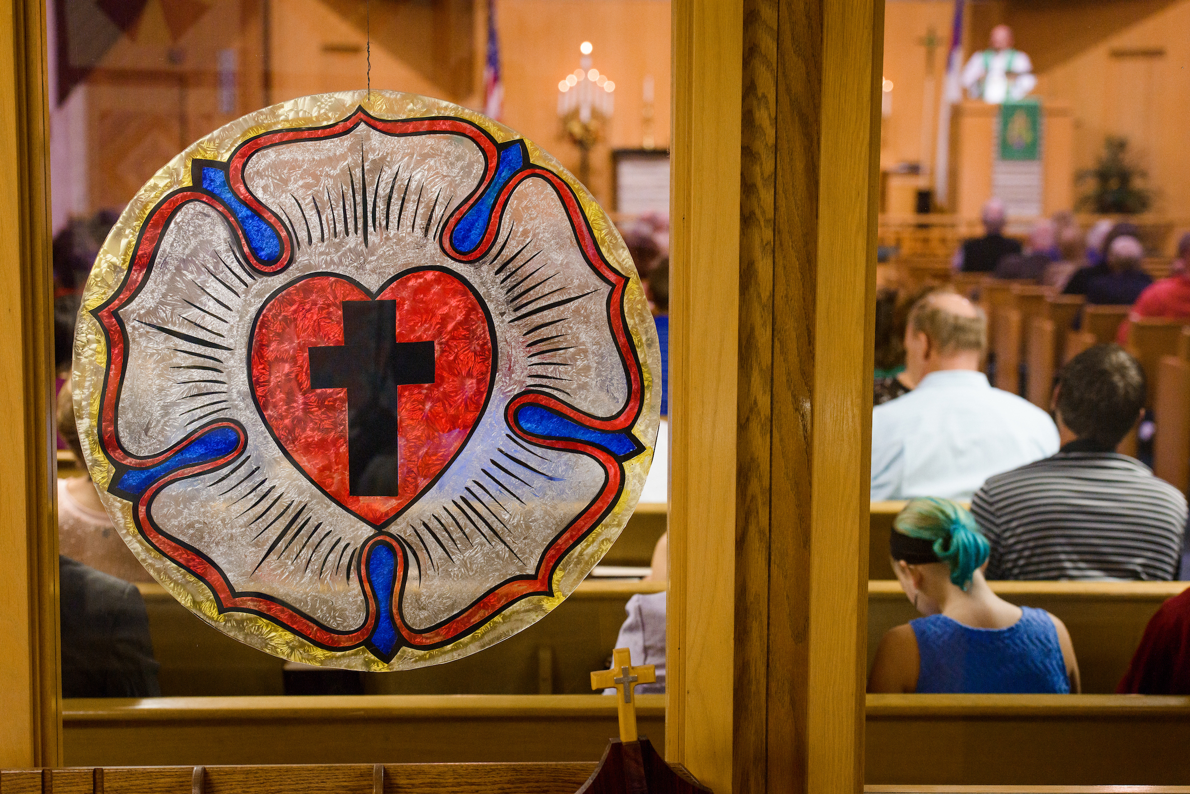 The Luther Rose hanging on the window in the narthex as the Rev. Dr. Heath Trampe preaches on Sunday, Sept. 24, 2017, at Faith Lutheran Church, York, Neb. LCMS Communications/Erik M. Lunsford