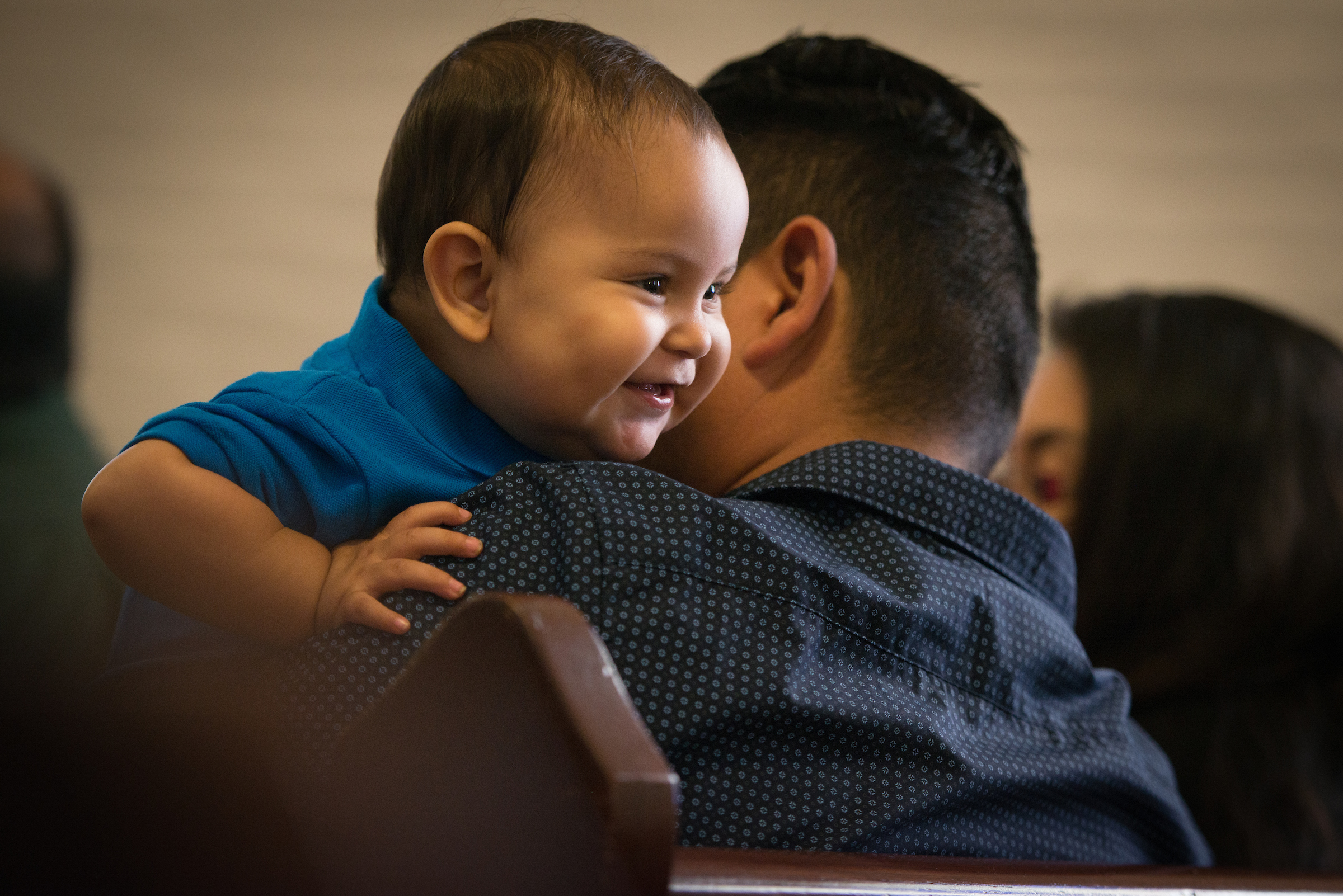 Daniel Anthony Lopez eyes a parishioner behind him as he plays on the lap of his father Daniel Lopez during worship at El Calvario Lutheran Church on Sunday, April 17, 2016, in Brownsville, Texas. LCMS Communications/Erik M. Lunsford