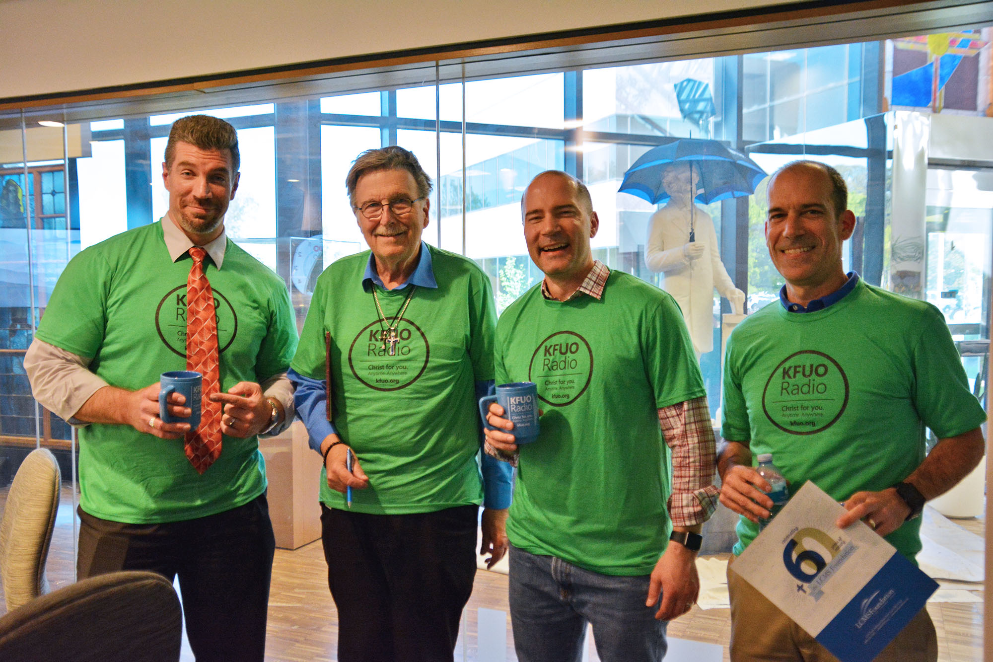 It's the Marks at Sharathon 2019! L-R: Rev. Mark Femmel, Rev. Mark Hawkinson, Rev. Mark Kiessling, and Mark Cannon showing off their KFUO t-shirts.