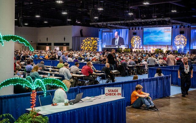 One of the pages (in orange) serving at the 67th Regular Convention of The Lutheran Church—Missouri Synod (LCMS) rests outside the delegate area on July 23 as elections for Synod boards take place on the convention floor. (LCMS/Erik M. Lunsford)