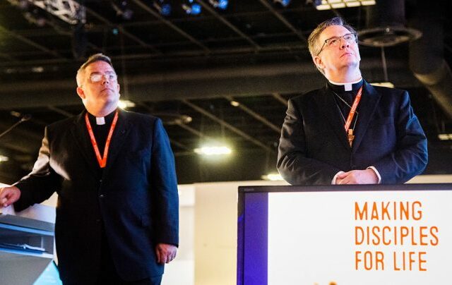 The Rev. Dr. R. Lee Hagan (left), chairman of Floor Committee 1 on National Witness, and the Rev. Christopher S. Esget, vice-chairman, join delegates in viewing a video on Making Disciples For Life, a new initiative of The Lutheran Church—Missouri Synod (LCMS). The video was part of the committee’s July 21 presentation to the 67th Regular Convention of the LCMS in Tampa, Fla. (LCMS/Frank Kohn)