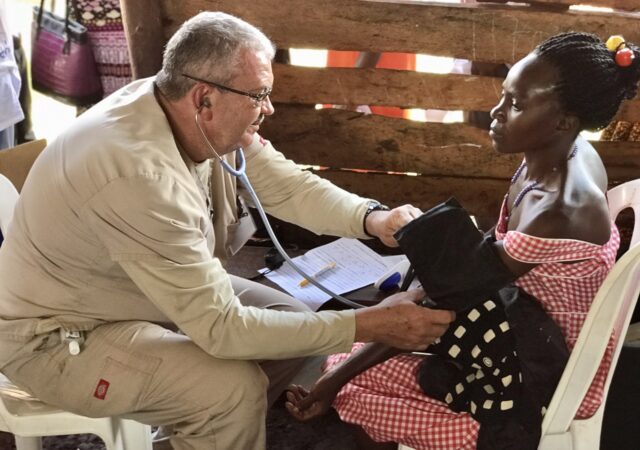 Ron Herman checks vital signs on a patient during the Mercy Medical Team trip to Uganda. Used with permission.