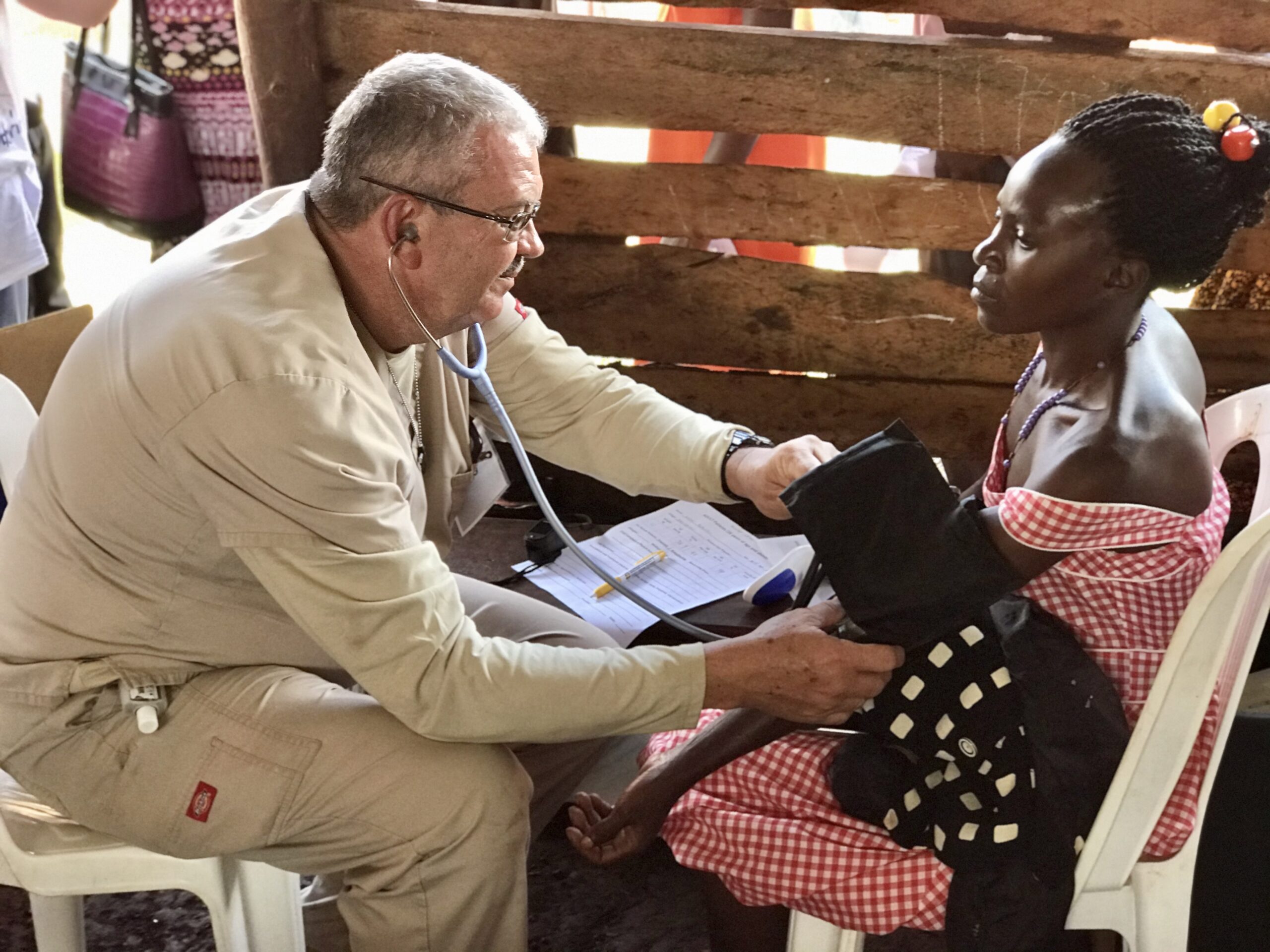 Ron Herman checks vital signs on a patient during the Mercy Medical Team trip to Uganda. Used with permission.