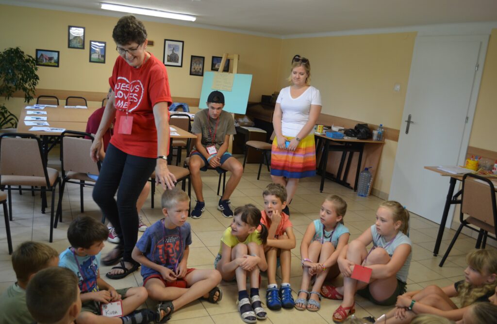 Joyce Kroll, volunteer for English Bible Camp in Poland, teaches her student.