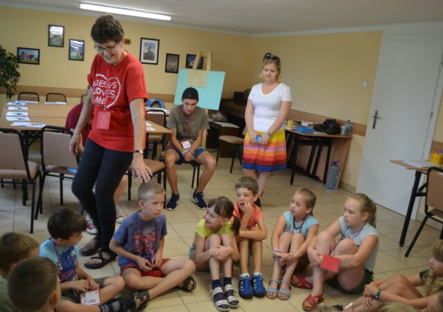 Joyce Kroll, volunteer for English Bible Camp in Poland, teaches her student.