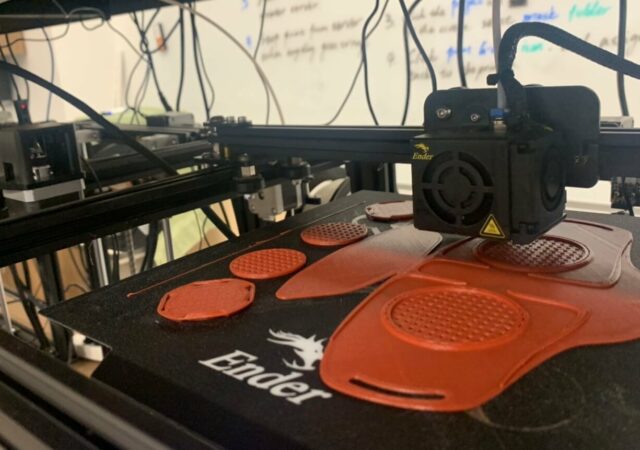 A 3D printer at the Concordia University Wisconsin Makerspace Lab prints a mask prototype.