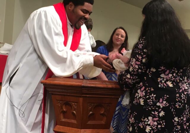 Rev. Gerard Bolling, associate pastor of Bethlehem Lutheran Church, baptizes a baby during a worship service. Used with permission.