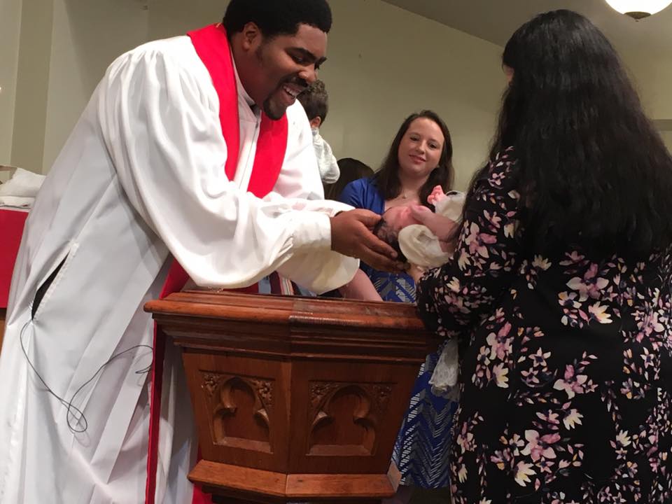 Rev. Gerard Bolling, associate pastor of Bethlehem Lutheran Church, baptizes a baby during a worship service. Used with permission.