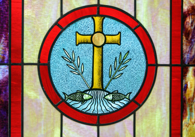 Stained glass depicting the cross at Zion Evangelical Lutheran Church, Lu Verne, Iowa, on Sunday, July 9, 2017. LCMS Communications/Erik M. Lunsford