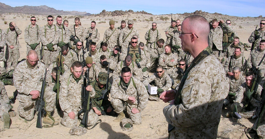 Marines bow their heads during a field service led by Chaplain Eric Malmstrom during his deployment to Iraq in 2005. (Photo courtesy of Eric Malmstrom)