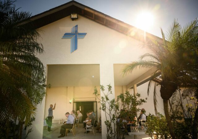 The Rev. Craig Mathews, vacancy pastor at Redeemer Lutheran Church, Englewood, Fla., gives the Benediction during Divine Service on Sunday, Oct. 2. The congregation held the service outside after damage from Hurricane Ian rendered the sanctuary unusable and without water or electricity. (LCMS/Erik M. Lunsford)