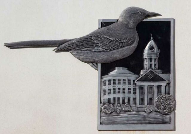 To Kill a Mockingbird_industrial-site-logo-in-monroeville-alabama-showing-the-bird-and-the-old-monroe-1 Podcast